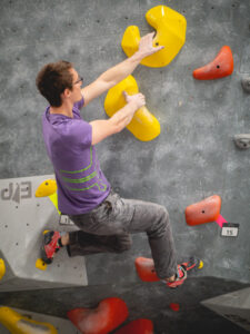 A climber dropping their knee for balance